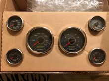 Gauges just showed up. Now to cut out the sheet of carbon fiber and make a panel so I can wire them up.