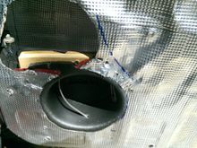 ring installed in cutout with coated deck screws.  You can see the blue sharpie swoop of the window crank (hence the scalloped cutout cutout on the MDF ring in the previous photo)  Also in the top left, you can see the door hinge stop.