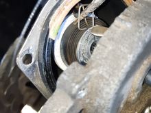 I actually did take a video of this but I think the picture and description show it fine. 

The bracket with the blue arrow goes where the pick is in the spring hole. Make sure the bracket is on the passenger side of the coil tab.