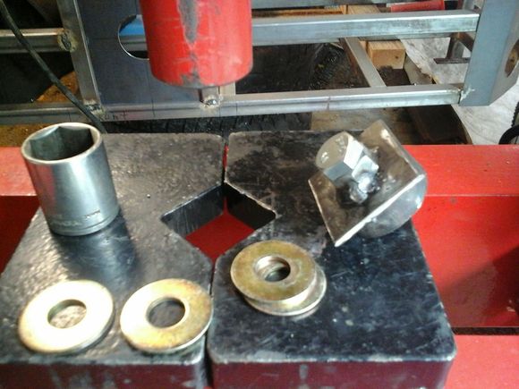 I basically welded a nut to the bottom of a square peice of plate steel. Then I welded a peice of tubing to the other side. Then threaded the bolt up though. I just happened to have the right size flat washers, so I used them as spacers and stacked them up inside the tubing until I got the depth I wanted