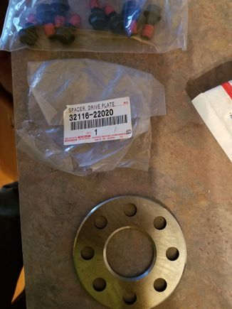 Part # for the spacer and the flywheel bolts part # 90105-10294 
 Both came from a Toyota parts website.
 1993 2jz Supra with 4 speed automatic