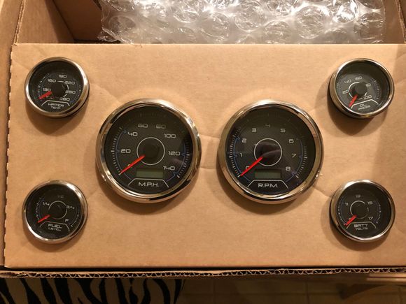 Gauges just showed up. Now to cut out the sheet of carbon fiber and make a panel so I can wire them up.