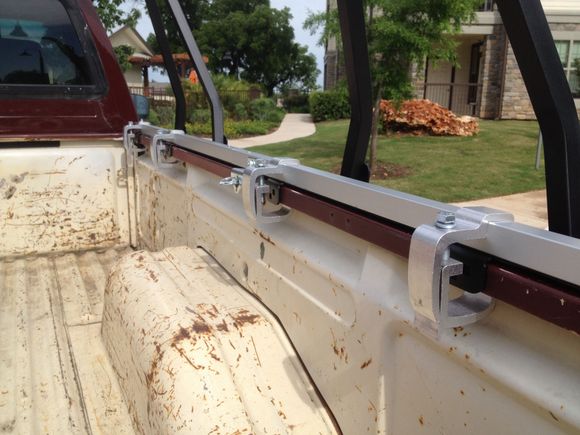 Slides under Softopper rail. Rail in this pic is Softopper hardware.