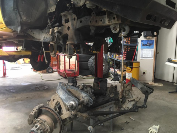 unbolt upper control arms, shocks, idler arm, pitman arm and torsion bars (the passenger side we cut the torsion bar because of the hard brake line routing and transfer case making it difficult to remove)