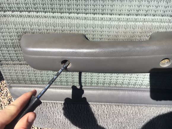 the screw covers for the door handle pull straight out.