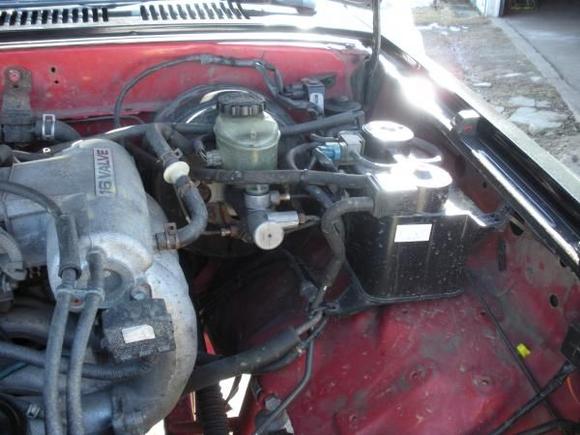 near the brake booster is the large emissions control system from the 1997.  fit good enough that zip ties worked for now.  i will fab some brackets when there is nothing better to do.