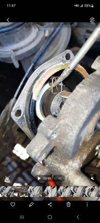 I actually did take a video of this but I think the picture and description show it fine. 

The bracket with the blue arrow goes where the pick is in the spring hole. Make sure the bracket is on the passenger side of the coil tab.