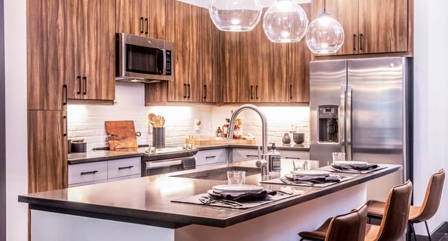 Our chef-inspired kitchens feature stainless steel appliances and side-by-side refrigerators.