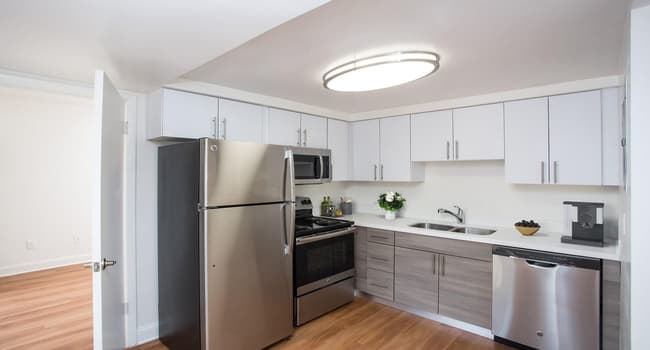 Renovated kitchen with quartz countertops and stainless steel appliances